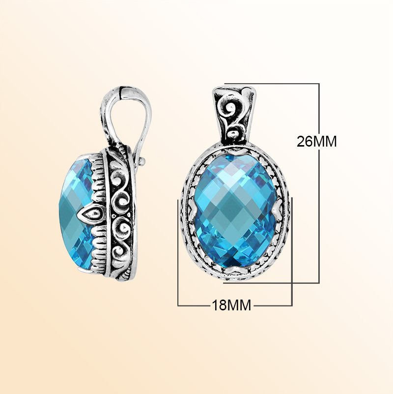 A handcrafted sterling silver pendant featuring an oval Blue Topaz Quartz centerpiece highlighted by artistic scroll carvings and a polished decorative frame for expressive everyday styling.