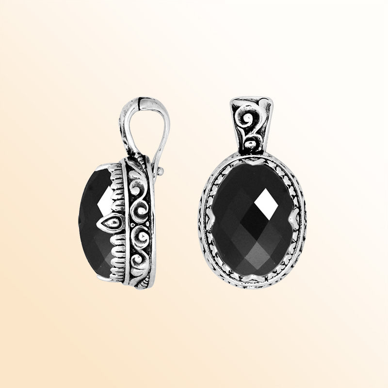 Handcrafted sterling silver pendant featuring a deep Black Onyx centerpiece accented with artistic Balinese scroll carvings and a polished decorative frame ideal for expressive everyday styling.
