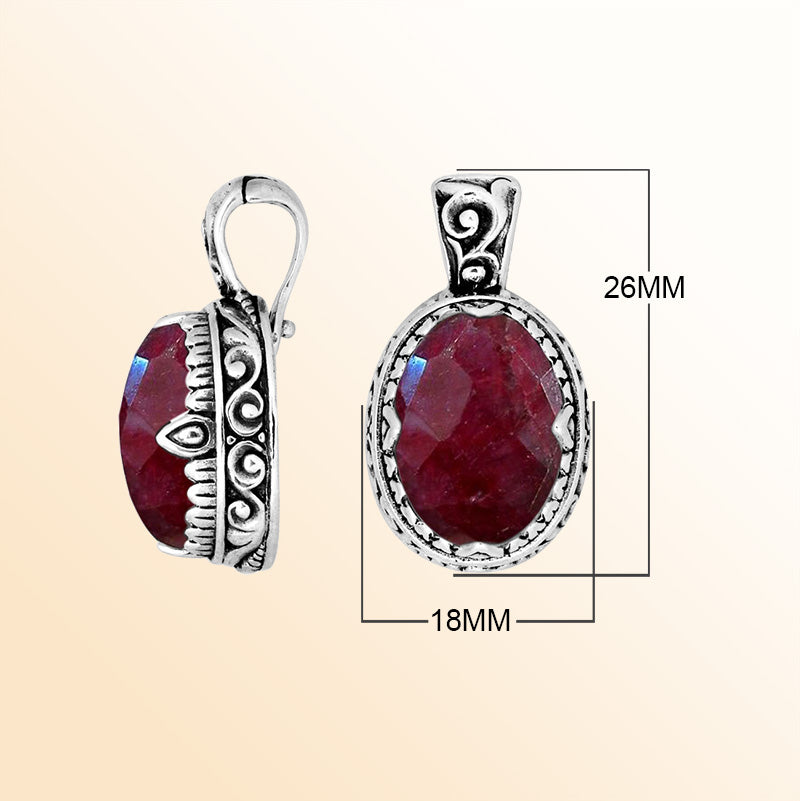 Handcrafted sterling silver pendant featuring a deep Ruby Quartz centerpiece surrounded by artistic Balinese scroll carvings and a smooth decorative frame for expressive personal styling.