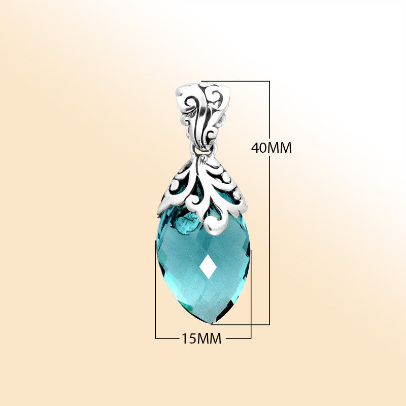 Handcrafted sterling silver marquise pendant featuring a faceted Blue Topaz Quartz centerpiece accentuated with artistic Balinese filigree carvings and a polished decorative frame.