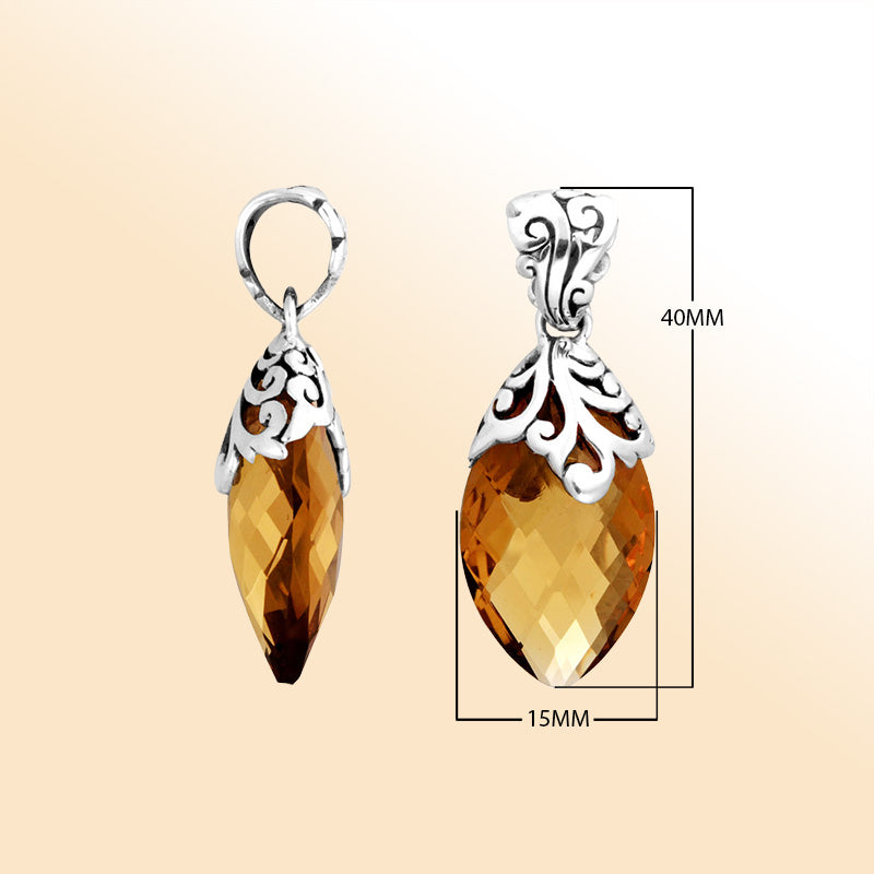 Handcrafted sterling silver marquise pendant featuring a faceted Citrine Quartz centerpiece surrounded by artistic Balinese filigree carvings and a polished decorative frame.