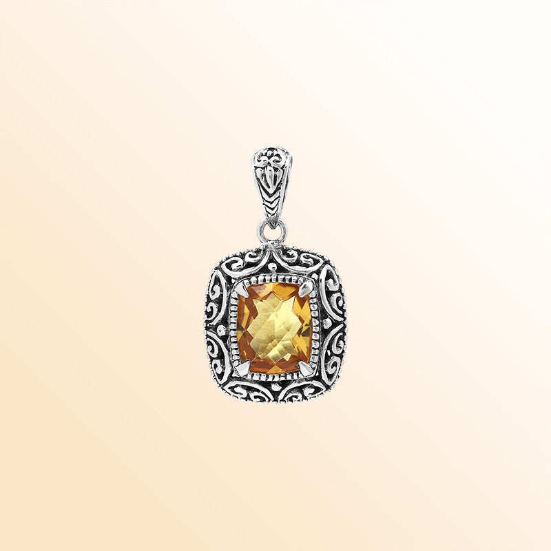 Handcrafted sterling silver cushion pendant featuring a faceted Citrine Quartz center enriched with artistic Balinese scroll carvings and a polished decorative frame.