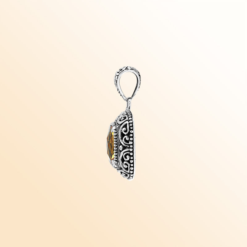 Handcrafted sterling silver cushion pendant featuring a faceted Citrine Quartz center enriched with artistic Balinese scroll carvings and a polished decorative frame.