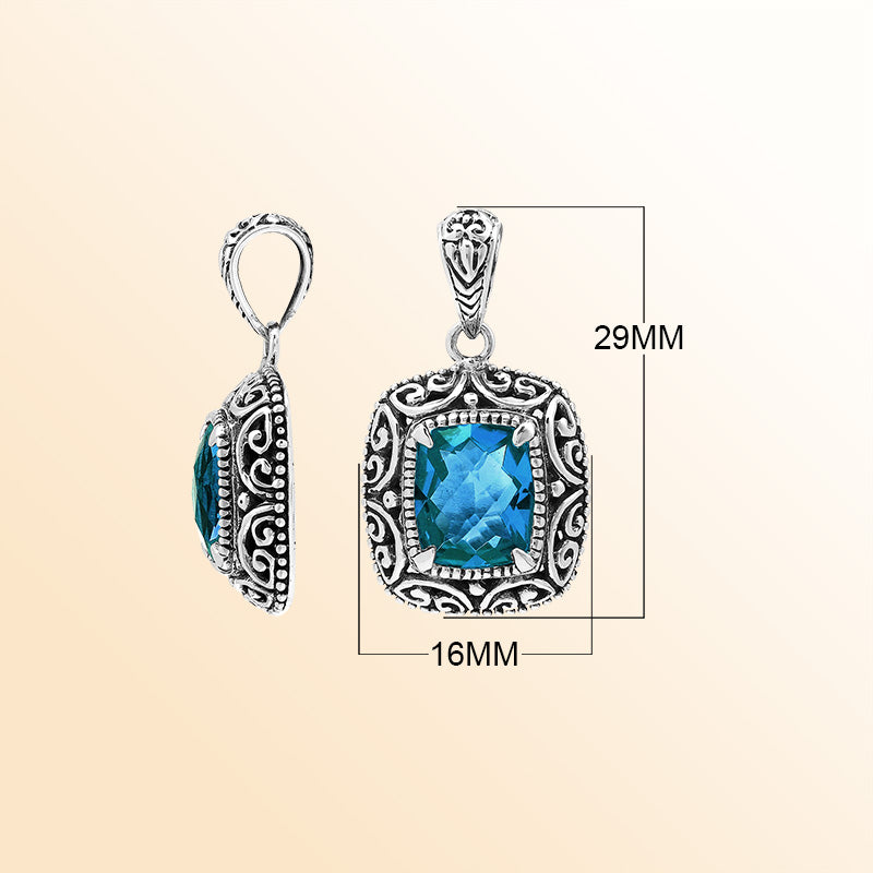 Handcrafted sterling silver cushion pendant showcasing a faceted London Blue Topaz Quartz centerpiece with artistic Balinese scroll carvings and a polished decorative frame.