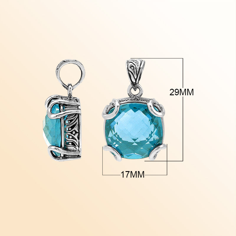 Handcrafted sterling silver cushion pendant featuring a faceted Blue Topaz Quartz centerpiece highlighted by artistic prong work and Balinese carved detailing.