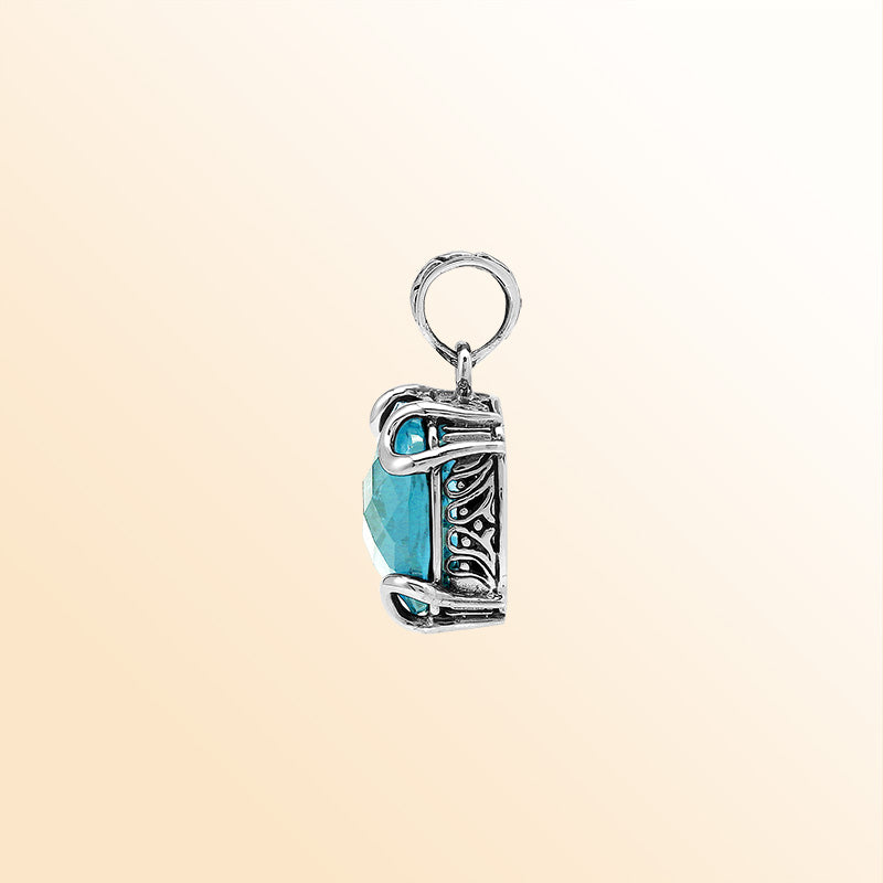 Handcrafted sterling silver cushion pendant featuring a faceted Blue Topaz Quartz centerpiece highlighted by artistic prong work and Balinese carved detailing.
