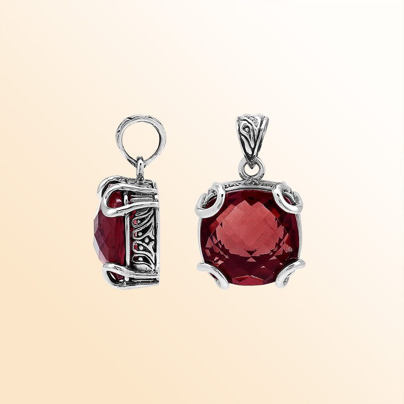 Handcrafted sterling silver cushion pendant featuring a vibrant Red Garnet Quartz centerpiece with expressive prong work and artistic Balinese carved embellishments.