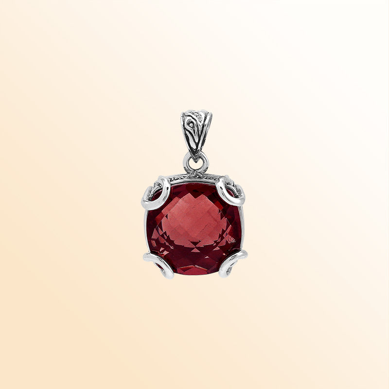 Handcrafted sterling silver cushion pendant featuring a vibrant Red Garnet Quartz centerpiece with expressive prong work and artistic Balinese carved embellishments.