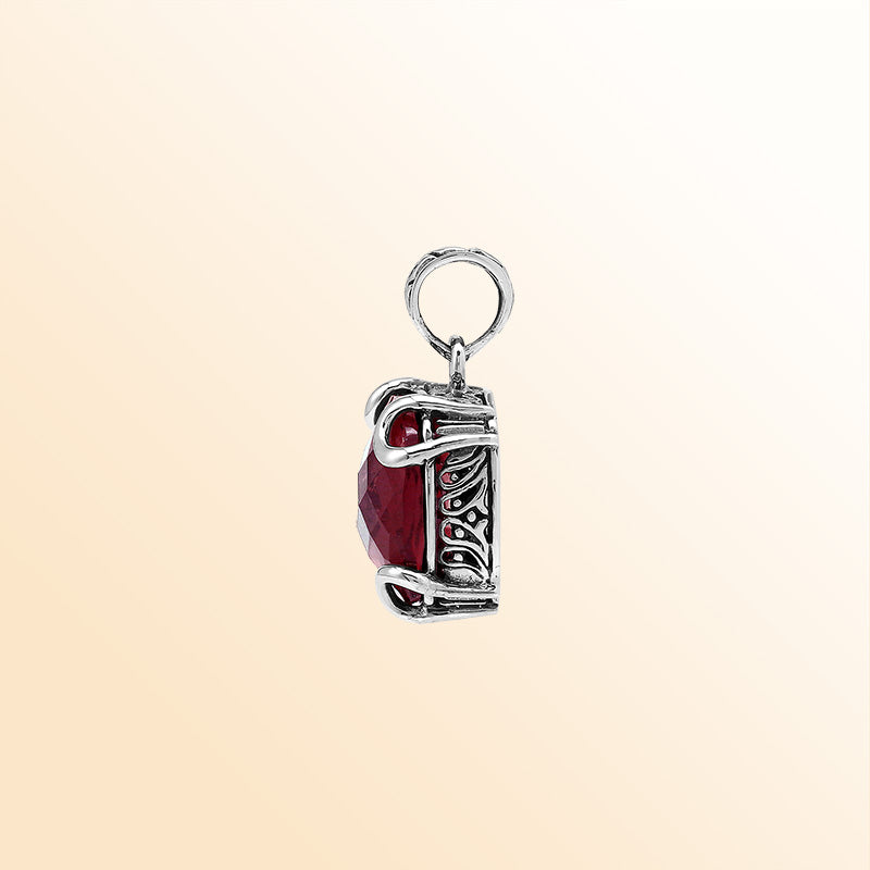 Handcrafted sterling silver cushion pendant featuring a vibrant Red Garnet Quartz centerpiece with expressive prong work and artistic Balinese carved embellishments.