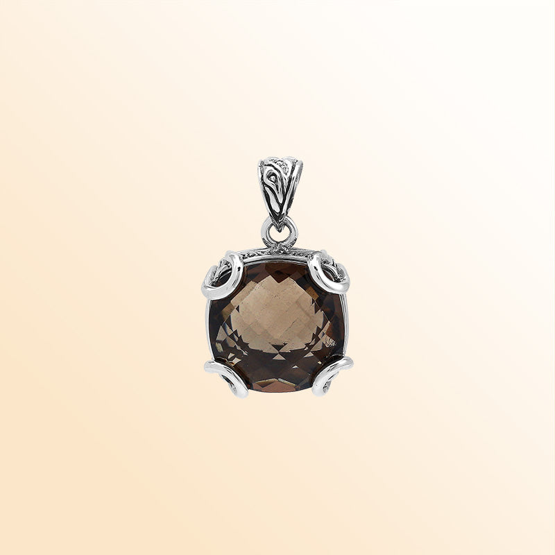 Handcrafted sterling silver cushion pendant featuring a faceted Smokey Quartz centerpiece accentuated with artistic prong work and carved Balinese decorative motifs.