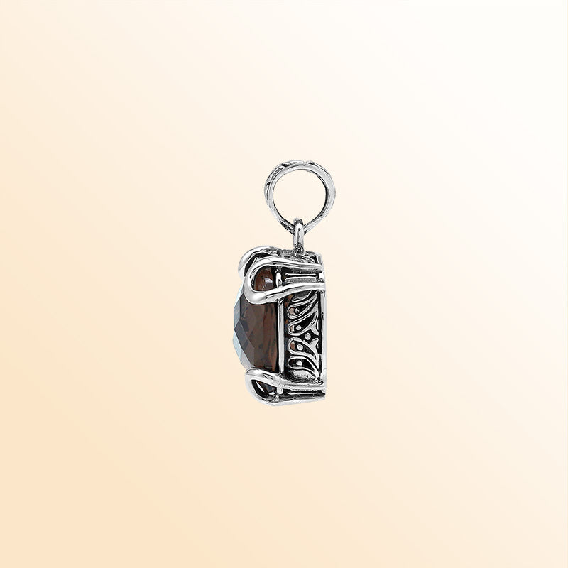 Handcrafted sterling silver cushion pendant featuring a faceted Smokey Quartz centerpiece accentuated with artistic prong work and carved Balinese decorative motifs.