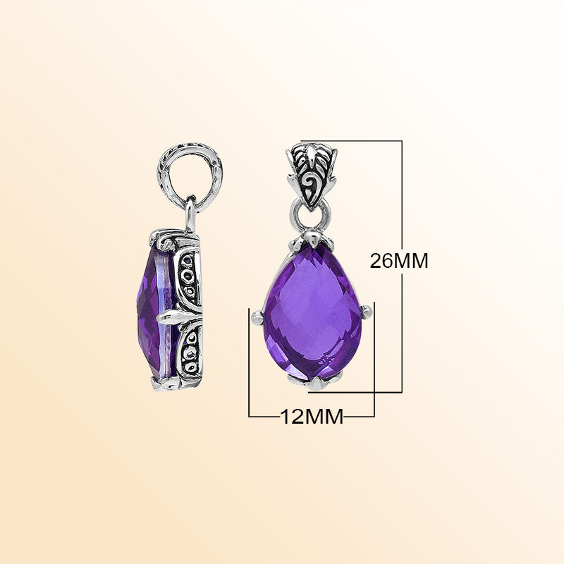 Handcrafted sterling silver pear-shaped pendant featuring a faceted Amethyst Quartz center with expressive prong work and graceful Balinese carved decorations.