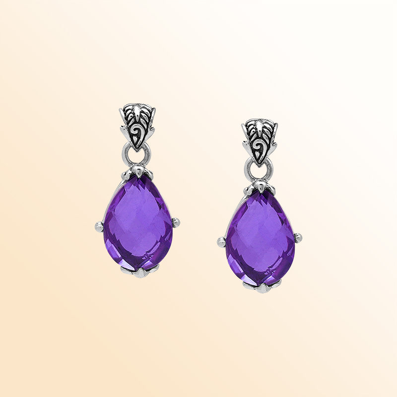 Handcrafted sterling silver pear-shaped pendant featuring a faceted Amethyst Quartz center with expressive prong work and graceful Balinese carved decorations.