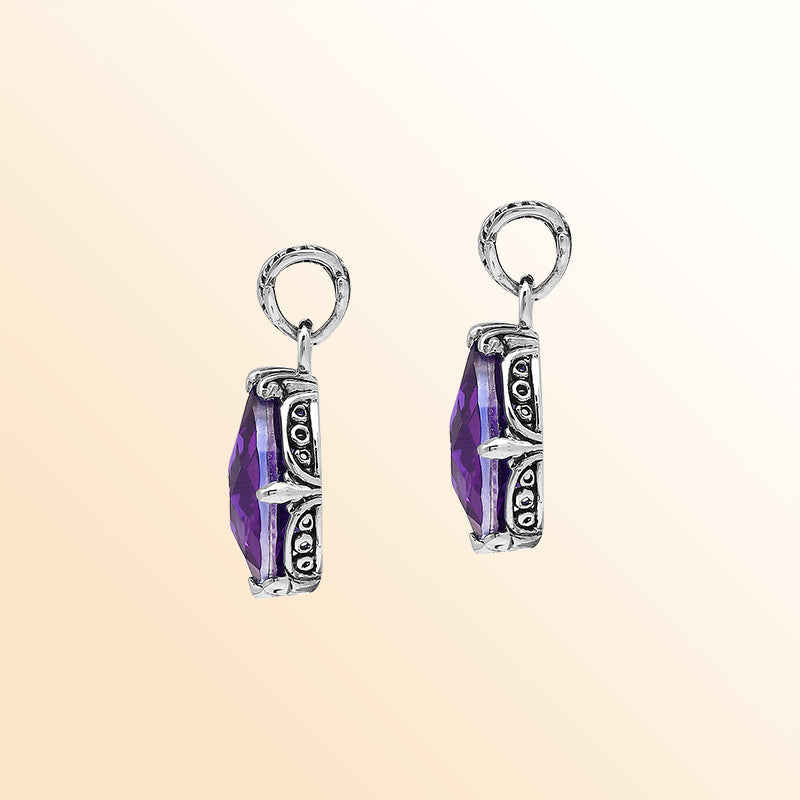 Handcrafted sterling silver pear-shaped pendant featuring a faceted Amethyst Quartz center with expressive prong work and graceful Balinese carved decorations.