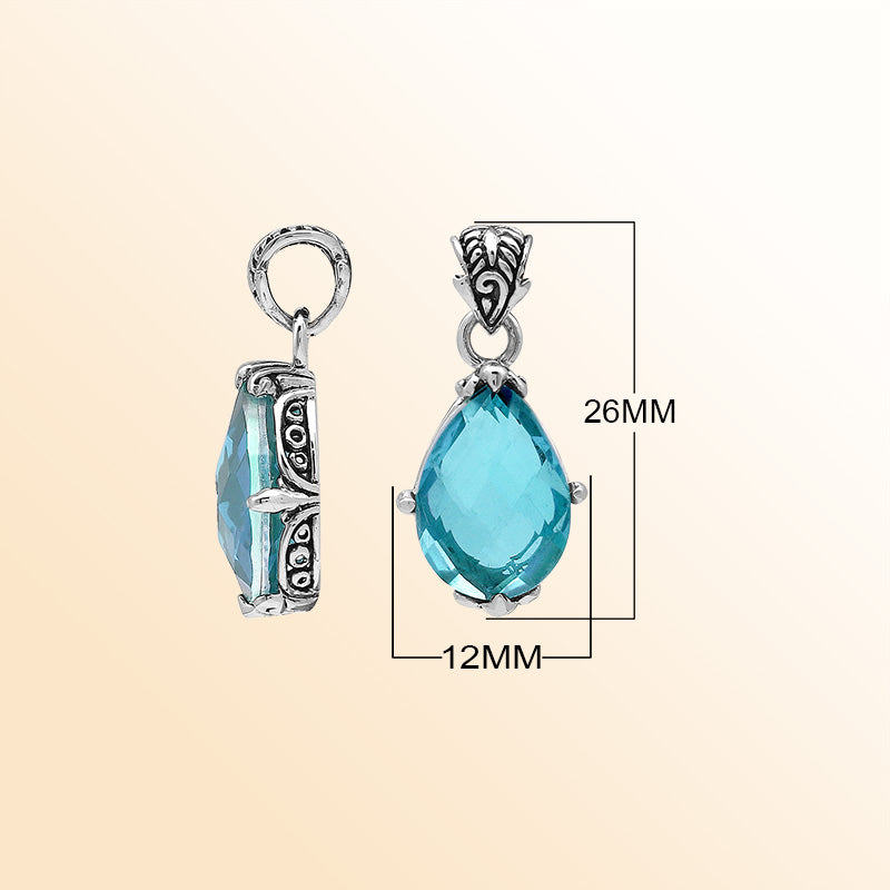Handcrafted sterling silver pear-shaped pendant featuring a faceted Blue Topaz Quartz center with expressive prong work and detailed Balinese carved embellishments.