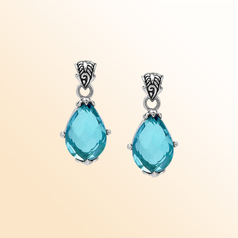 Handcrafted sterling silver pear-shaped pendant featuring a faceted Blue Topaz Quartz center with expressive prong work and detailed Balinese carved embellishments.