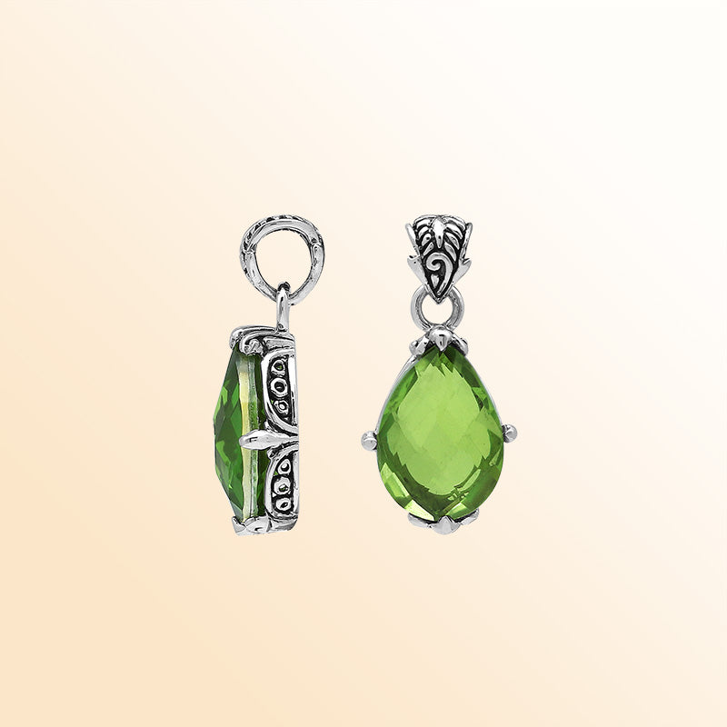 Handcrafted sterling silver pear-shaped pendant featuring a faceted Peridot Quartz center with artistic prong-setting and ornate Balinese carved accents.