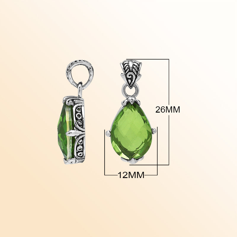 Handcrafted sterling silver pear-shaped pendant featuring a faceted Peridot Quartz center with artistic prong-setting and ornate Balinese carved accents.