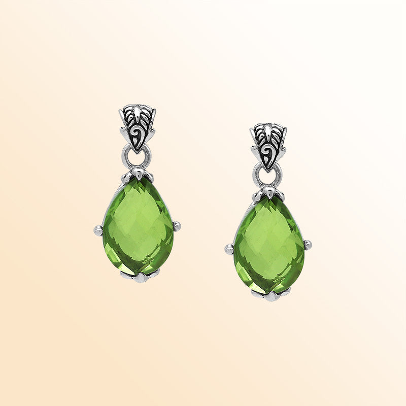 Handcrafted sterling silver pear-shaped pendant featuring a faceted Peridot Quartz center with artistic prong-setting and ornate Balinese carved accents.