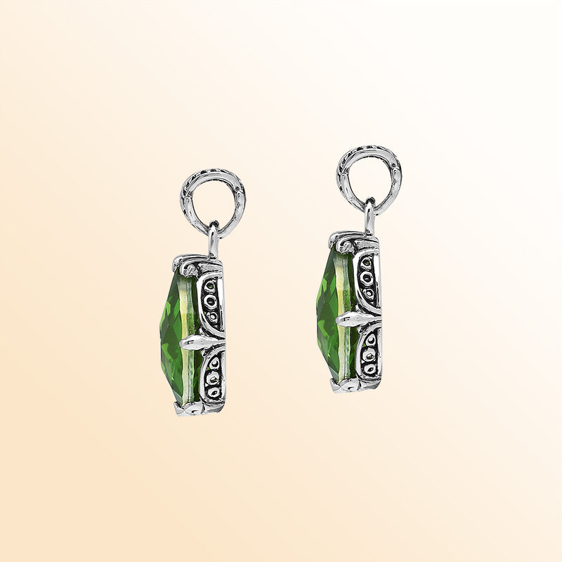 Handcrafted sterling silver pear-shaped pendant featuring a faceted Peridot Quartz center with artistic prong-setting and ornate Balinese carved accents.