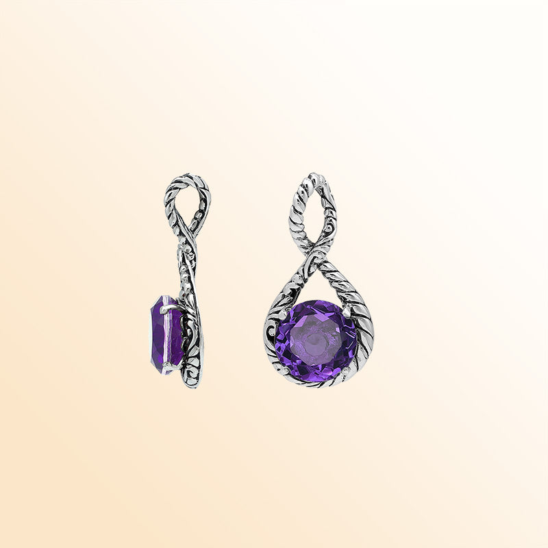 Handcrafted sterling silver twisted loop pendant featuring a round faceted Amethyst Quartz with artistic engraved detailing and expressive Balinese styling.