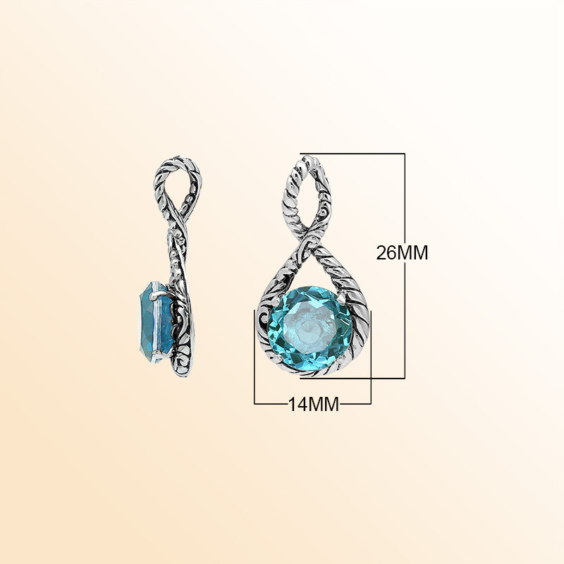 Handcrafted sterling silver twisted loop pendant featuring a faceted Blue Topaz Quartz centerpiece with artistic engraved detailing and Balinese styling.