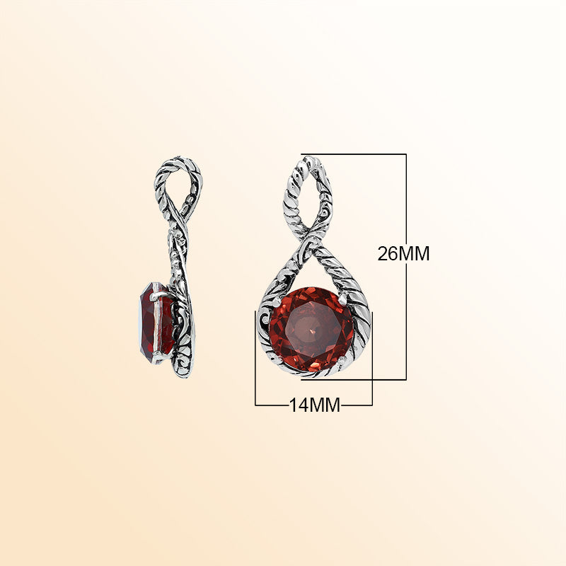 Handcrafted sterling silver twisted loop pendant featuring a round Red Garnet Quartz centerpiece with artistic engraving and expressive Balinese detailing.
