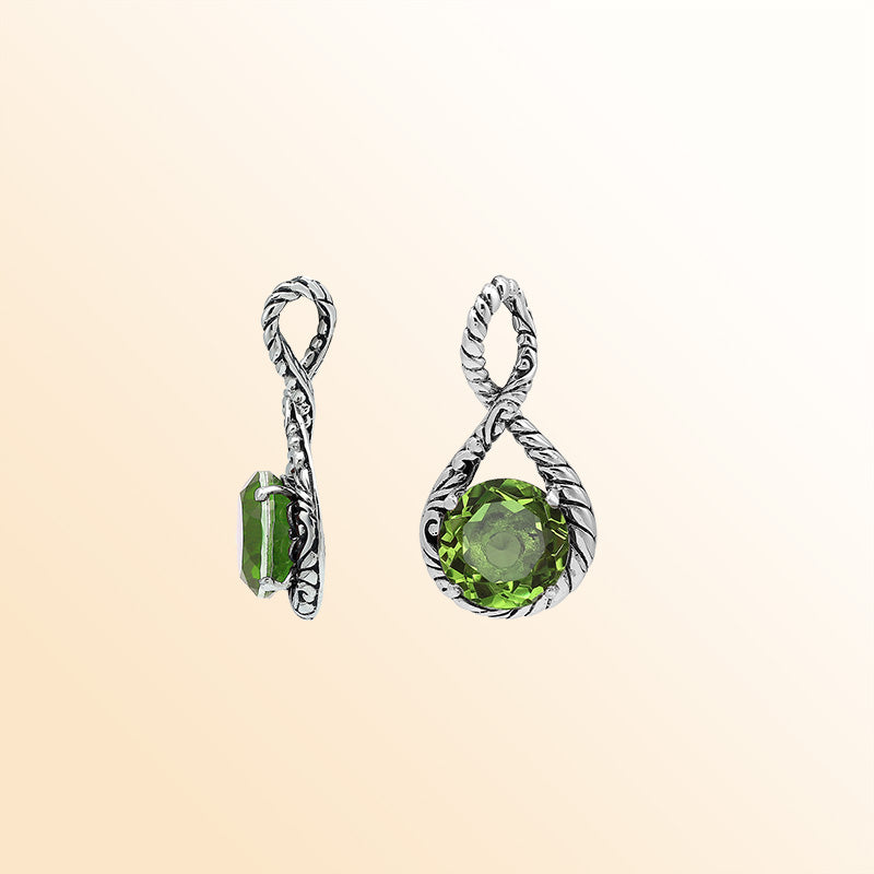Handcrafted sterling silver twisted loop pendant showcasing a round Peridot Quartz stone with ornate Balinese engraving and polished artistic detailing.