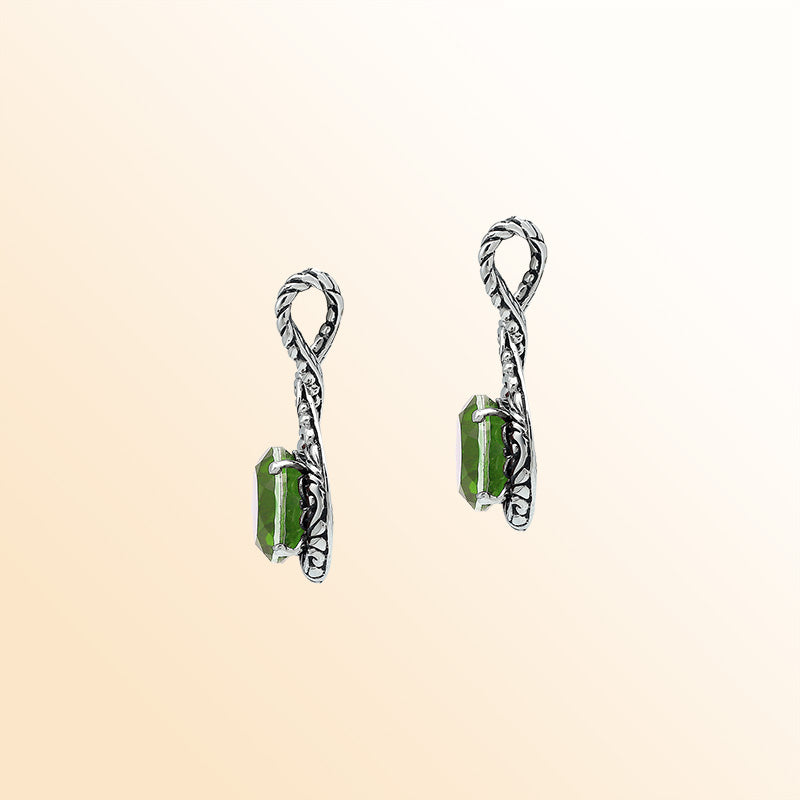 Handcrafted sterling silver twisted loop pendant showcasing a round Peridot Quartz stone with ornate Balinese engraving and polished artistic detailing.