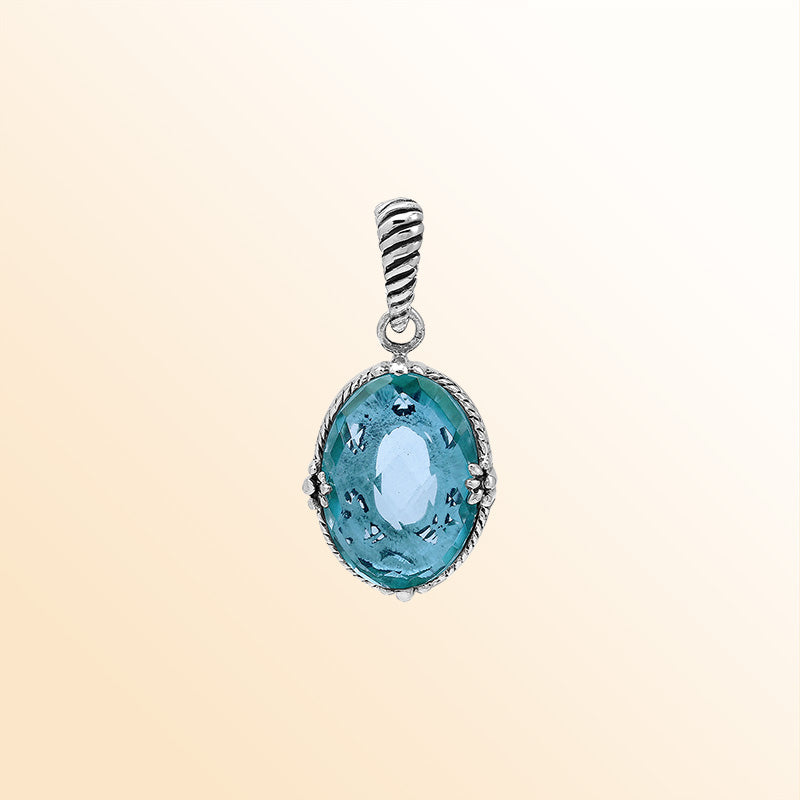 Handcrafted sterling silver oval pendant featuring Blue Topaz Quartz with rope-textured Balinese accents.