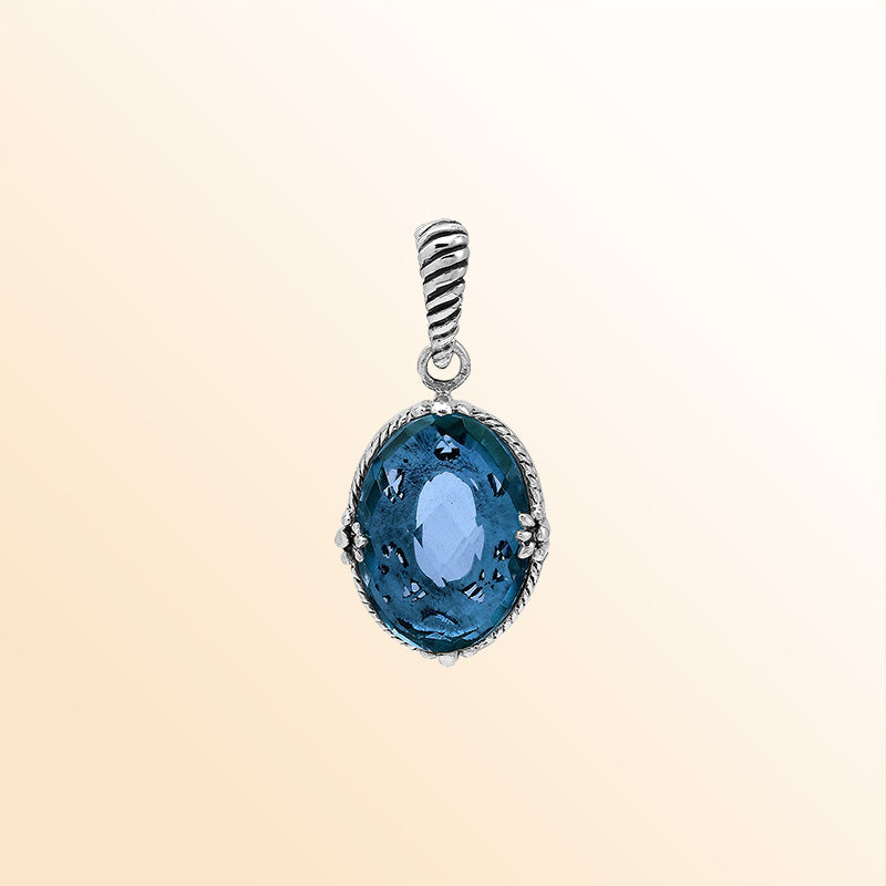 Handcrafted sterling silver pendant featuring London Blue Topaz Quartz in a rope-textured Balinese oval frame.