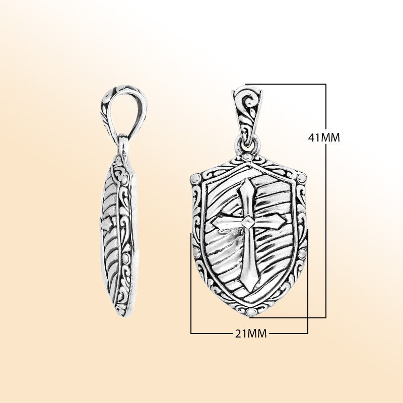 Artistic sterling silver shield pendant featuring an engraved cross design with textured background, polished borders, and expressive handcrafted-inspired detailing for modern jewelry lovers