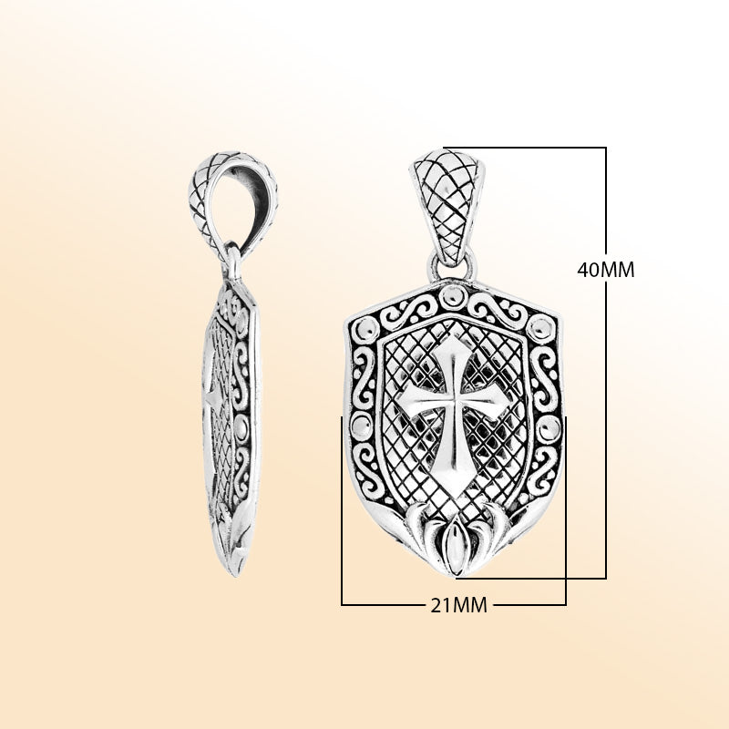 Artistic sterling silver shield pendant featuring an engraved cross with decorative scrollwork and a textured background for expressive modern handcrafted-inspired jewelry styling