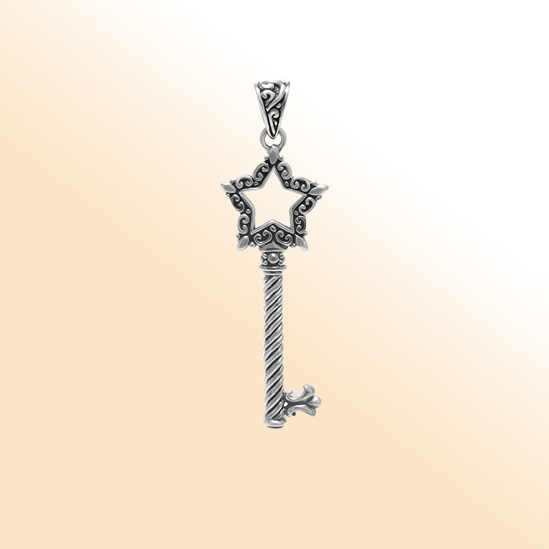 Artistic sterling silver star-shaped key pendant with detailed filigree accents, twisted stem, and polished bright finish for modern expressive jewelry wearers