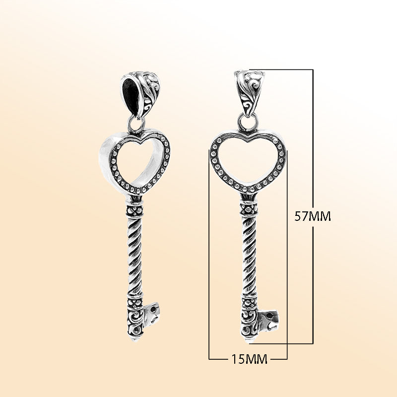 Artistic sterling silver heart-shaped key pendant with dotted textured accents, twisted stem, and polished finish designed for modern expressive jewelry wearers