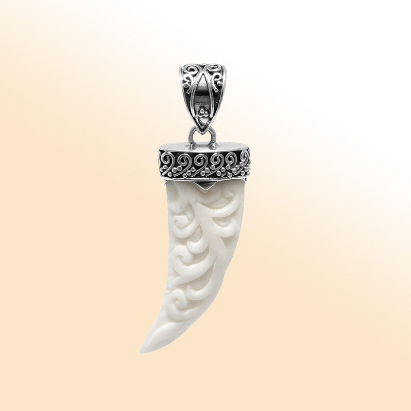 Artistic sterling silver carved bone horn pendant with Balinese decorative cap and polished finish designed for modern expressive jewelry wearers