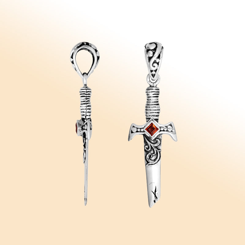 Artistic sterling silver sword pendant featuring carved guard details and a square Red Garnet Quartz accent for modern expressive jewelry wearers