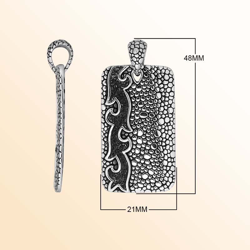 Artistic sterling silver rectangle pendant with pebble texture and carved accents.