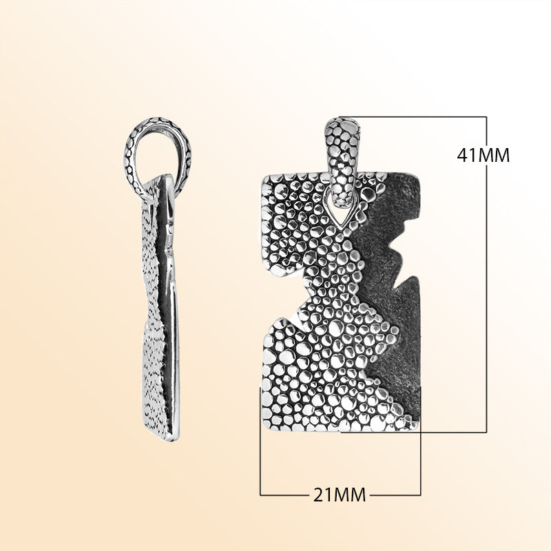 Artistic sterling silver rectangle pendant with cracked divider and pebble texture.
