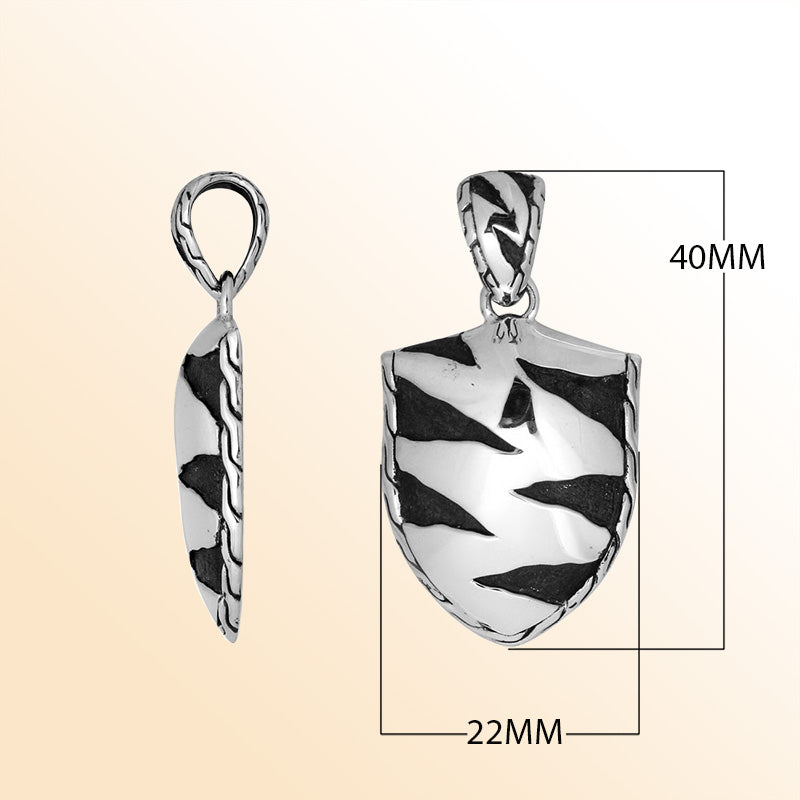 Artistic sterling silver shield pendant with oxidized wavy carved detailing.