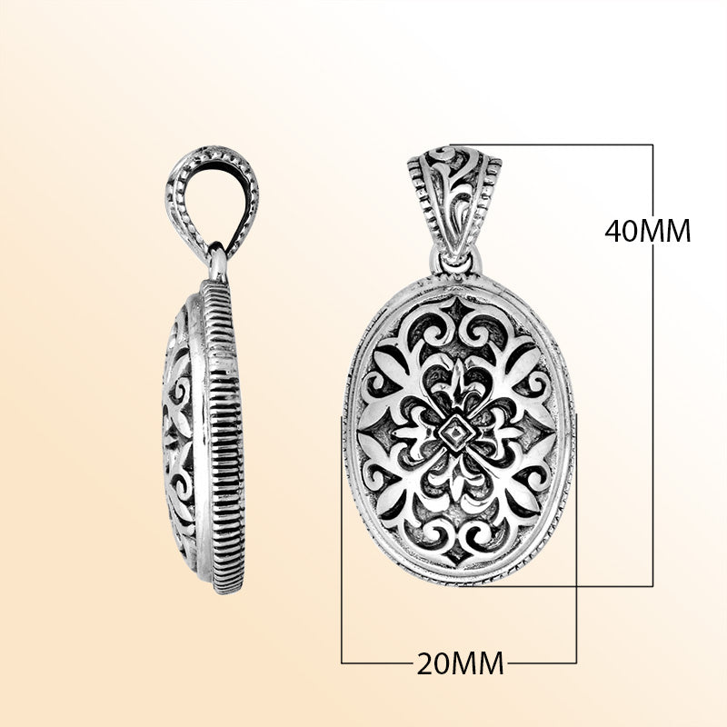 Artistic sterling silver oval pendant with floral carved motif.