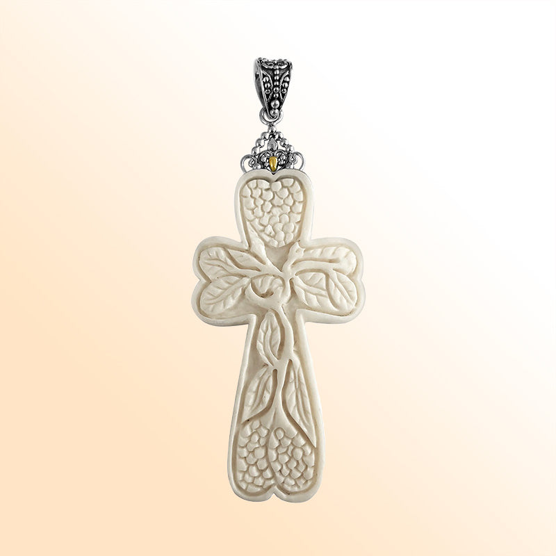 Artistic sterling silver cross pendant with hand-carved bone floral design.