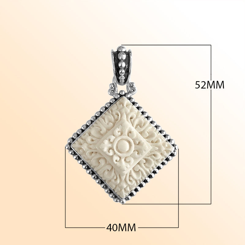 Artistic sterling silver square pendant with hand-carved bone centerpiece.
