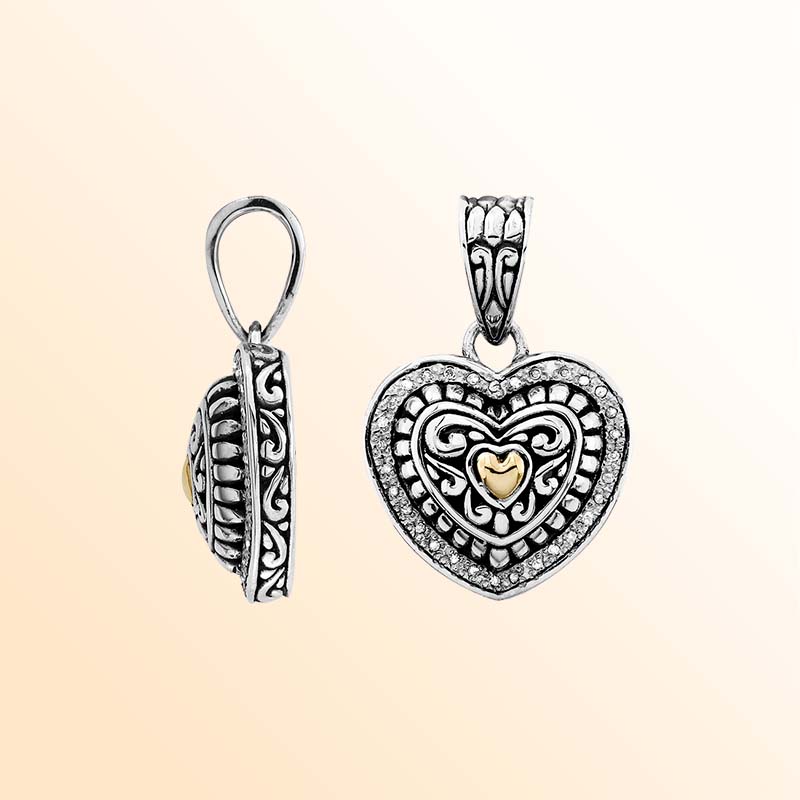 Artistic heart pendant with diamond and 18K gold crafted in sterling silver.