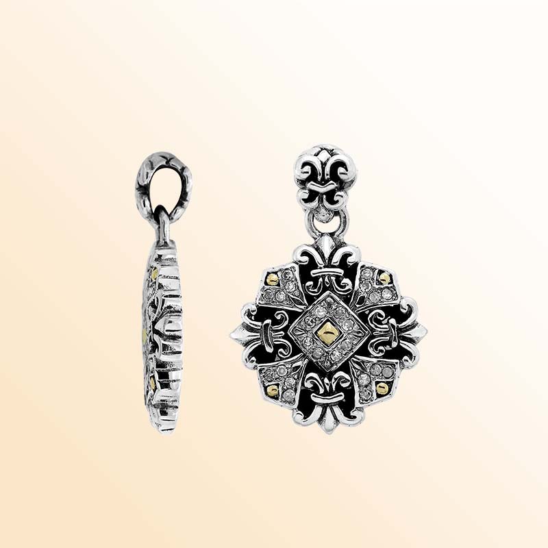 A handcrafted sterling silver and 18K gold fleur-inspired pendant featuring sparkling diamond accents, intricate Balinese patterns, oxidized textures, and expressive two-tone artistry ideal for elegant everyday wear.