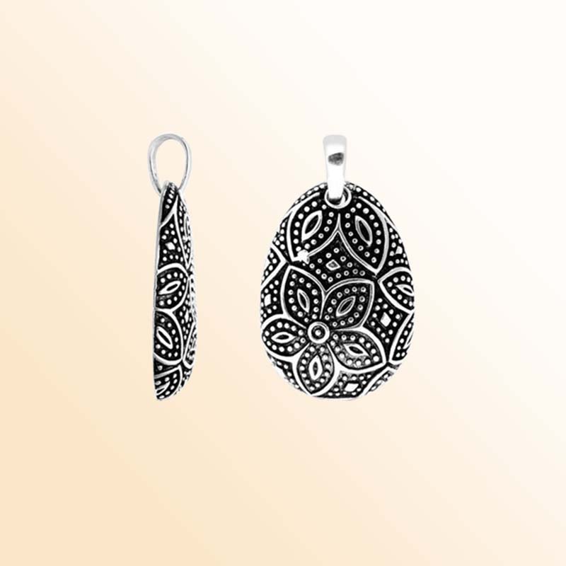 A handcrafted Silver Overlay Over Copper pendant featuring floral etched motifs, dotted detailing, oxidized Balinese textures, and polished overlay artistry perfect for elegant everyday wear.