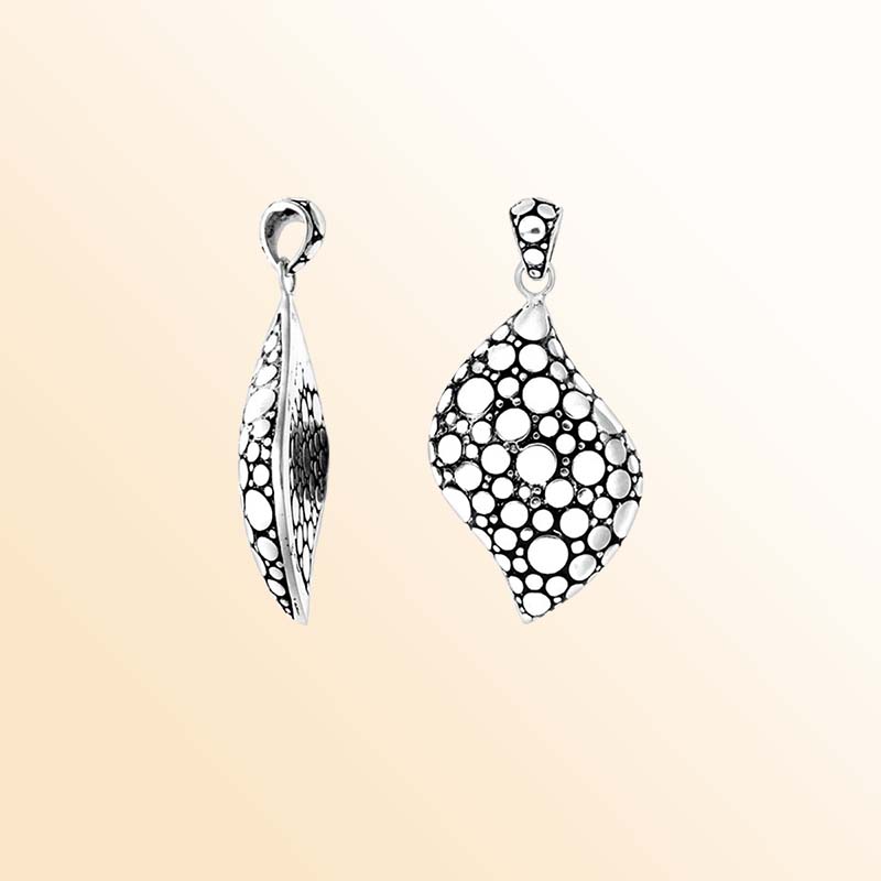 A handcrafted Silver Overlay Over Copper pendant featuring a modern wave shape with artistic bubble cutout patterns, oxidized detailing, and a polished Balinese silver overlay finish.