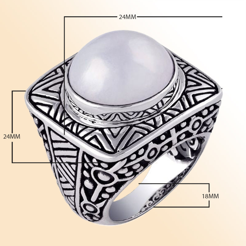 Sterling silver statement ring with a luminous white Mabe Pearl centerpiece, set on a bold square band with detailed Bali-inspired carvings.