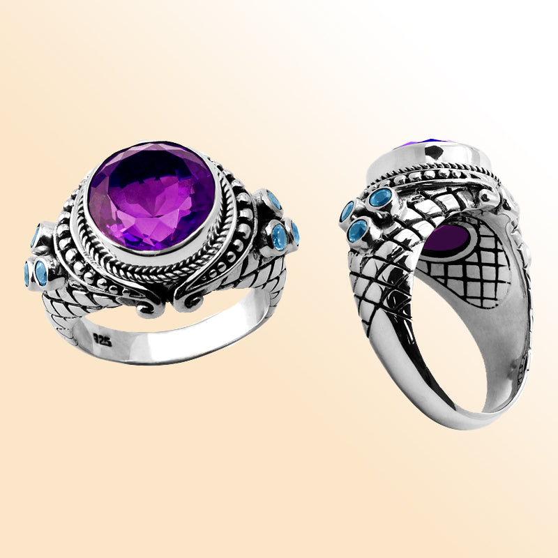 Sterling silver statement ring with faceted round amethyst quartz center and sparkling blue topaz quartz accents, detailed with Bali-inspired rope and scroll design – elegant artisan jewelry for women.