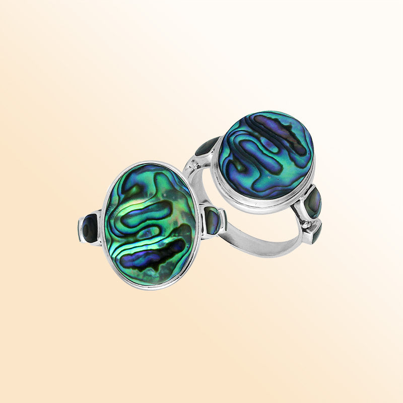 Sterling silver oval Abalone Shell ring with shimmering side inlays, handcrafted artisan jewelry featuring iridescent shell for women.
